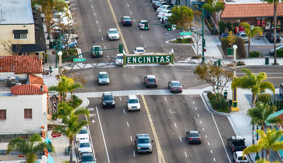 Aerial view of Downtown Encinitas with traffic under landmark "Encinitas" sign