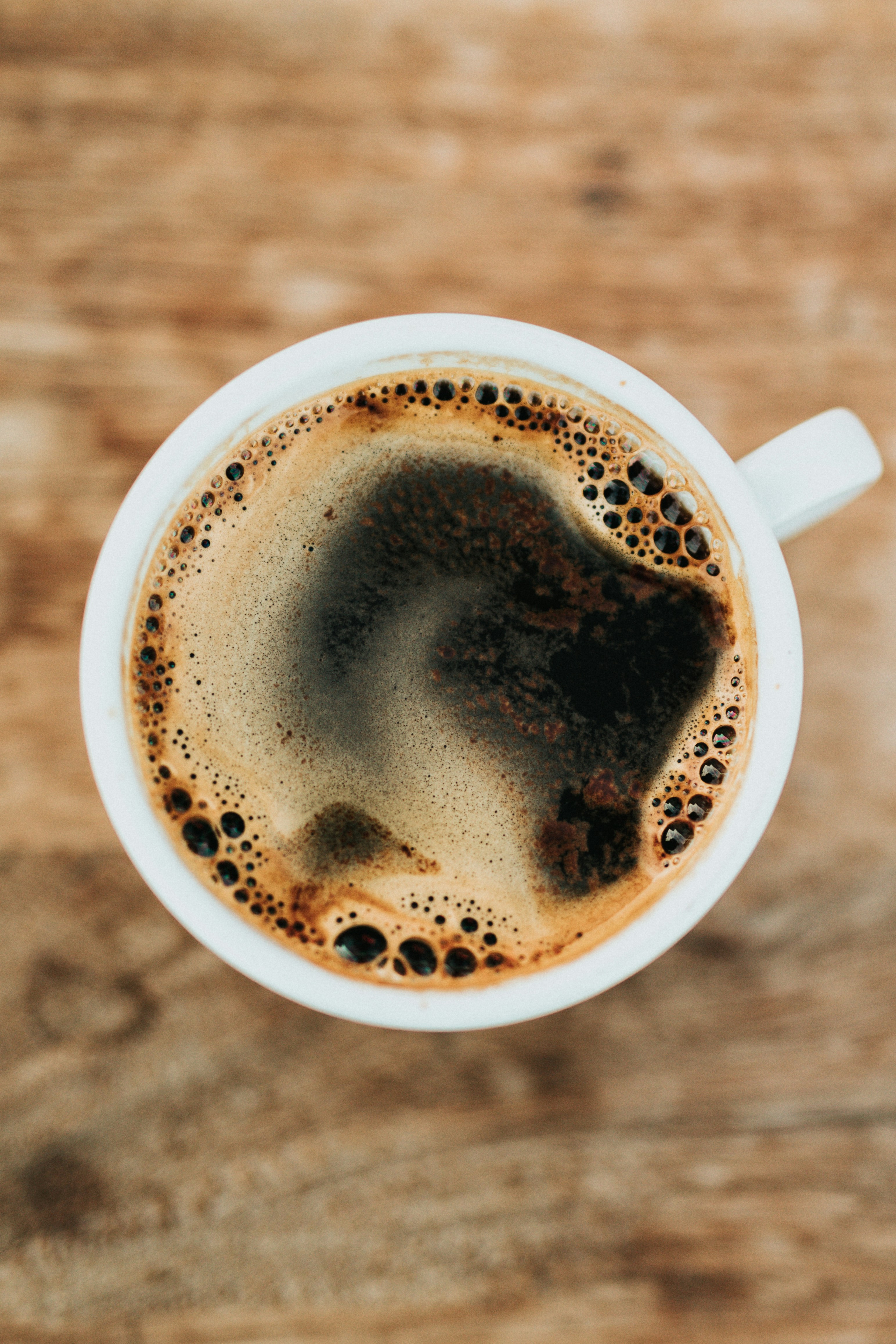 Close-up of espresso pouring from a coffee machine into a coffee cup